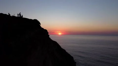 Sunset view of the Atlantic Ocean with the silhouette of the coast line at Praia Stockbeeldmateriaal 166588728