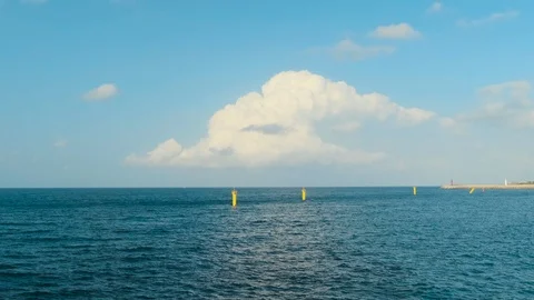 A sunset view with beautiful, rich clouds, blue skies, and the horizon of the se Stock Footage 119509865