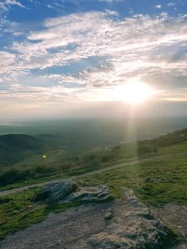 Sunset view blue sky and nature landscape sun light clouds sunlight hill Stock Photos