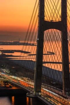Sunset view of a bridge with light trails and city skyline in Osaka, Japan Stock Photos