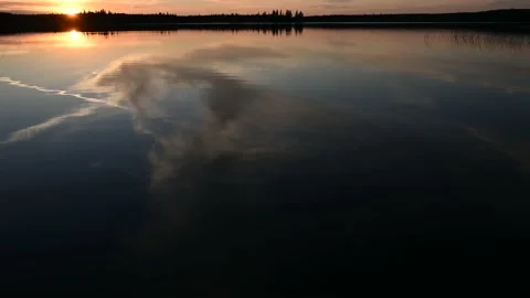 Sunset view of a calm lake with dark blue color, small water ripples  Stock Footage 156475243