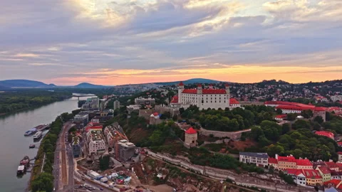 Sunset view of a city beside a river with buildings and hills in the background Stock Footage 341378771