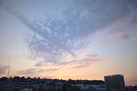 Sunset view of clouds above metropolitan area Stock Photos