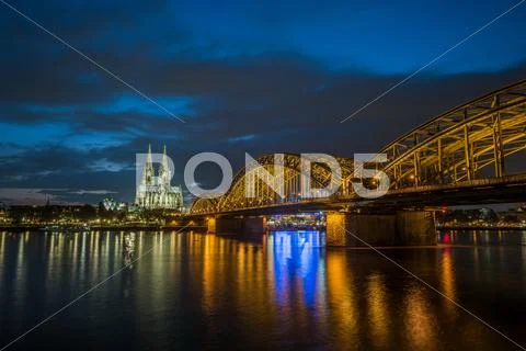Sunset view of Cologne Cathedral and Hohenzollern Bridge Stock Photos