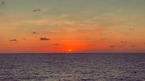 Sunset view with colorful sky and ocean waves creating a serene and tranqui.. Stock Footage 338280508