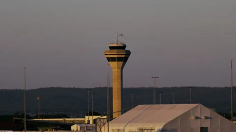 Sunset View of a Control Tower at an Airport With Airplane Approaching for Stock Footage 274347240