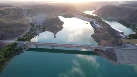 Sunset with a view of the dam and bridge. Video stock 155567296