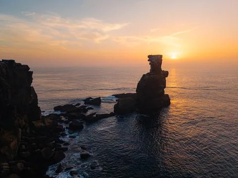Sunset view of dramatic sea stack and rocky Atlantic coastline in Portugal,.. Stock Photos