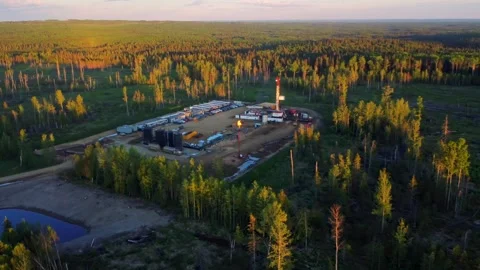Sunset View of a Drilling Rig with H2S Flare Flames, Alberta, Canada Stock Footage 341389791