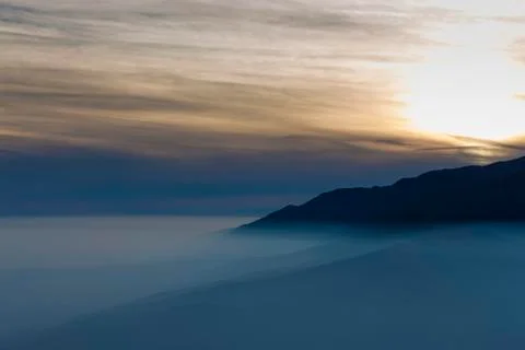 Sunset view with fog Stock Photos