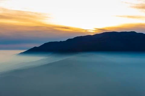 Sunset view with fog Stock Photos