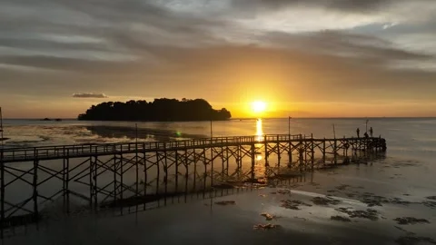 Sunset view in front of jetty and island by aerial drone Stock Footage 277849996