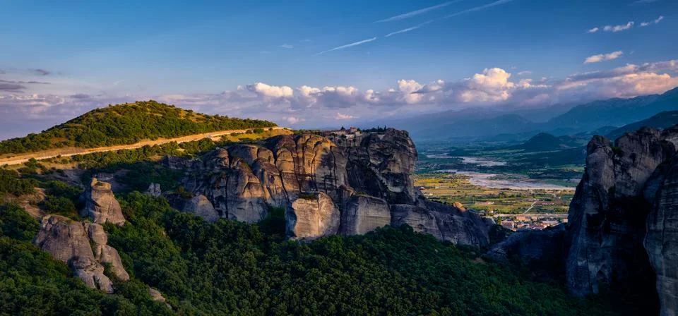 Sunset view of Holy Trinity or Agia Triada monastery on rock top. Meteora Stock Photos