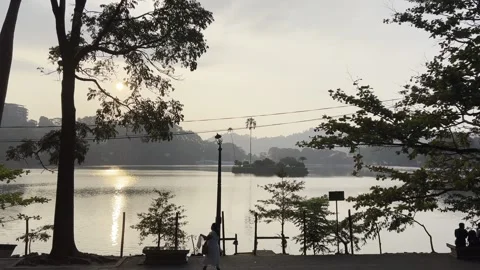 Sunset View of Kandy Lake With People Walking Along Waterfront Video stock 331531654