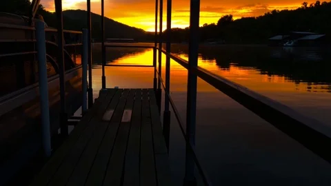 Sunset view of lake from a boat dock - moving forward Stock Footage 99368558