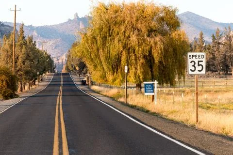 Sunset view of Lambert Road next to Smith Rock State Park in the background Stock Photos