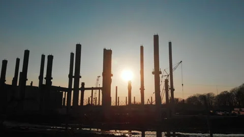 Sunset view landscape at construction site. New factory building cement poles Stock Footage 163225806