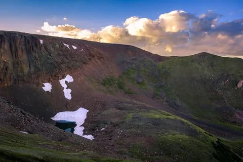 Sunset View of Lava Cliffs and Alpine Lake, Rocky Mountain National Park Stock Photos