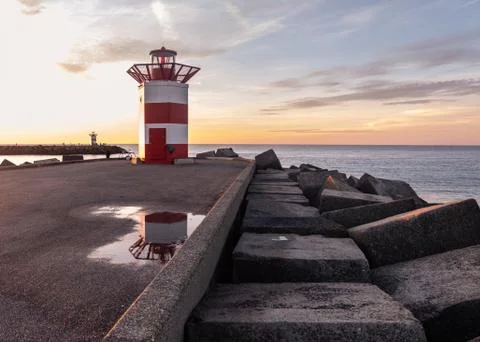 Sunset view on lighthouse and it's reflection Stock Photos