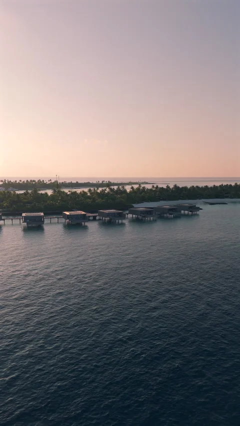 Sunset view of luxury bunglows on a tropical island in Maldives Stock Footage 309516518