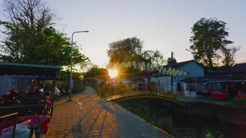 Sunset view of Mea Kha Canal and pedestrian bridge in Chiang Mai Thailand Stock Footage 342336159