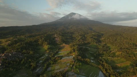 Sunset view of mount Agung, Bali surrounded by green rice fields Stock Footage 260029069