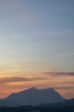 Sunset view of a mountain range with orange and blue sky Stock Photos