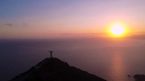 Sunset View From a Mountain With the Statue of Jesus Overlooking the Ocean. Stock Footage 322934556
