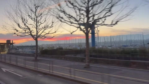 Sunset view from a moving bus along the shore of Lake Geneva Stock Footage 304392300