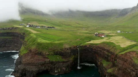 Sunset view of Mulafossur Waterfall and Gasadalur village. Vagar, Faroe Islands. Video stock 167848875