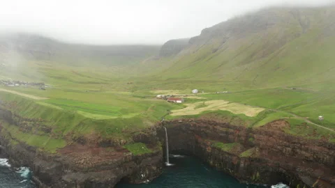 Sunset view of Mulafossur Waterfall and Gasadalur village. Vagar, Faroe Islands. Stock Footage 243343102
