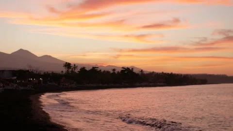 Sunset view on ocean and mountains from beach Stock Footage 160252725