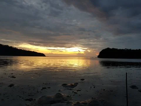 Sunset view of the ocean from a beach Stock Photos