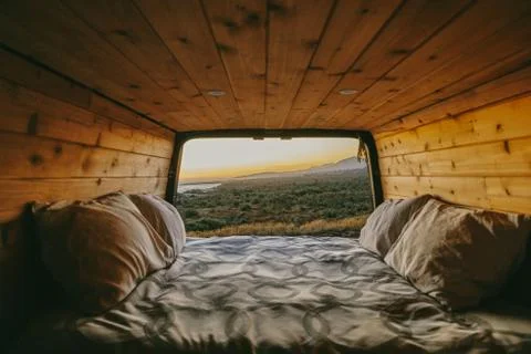 Sunset view of ocean over cliffs from bed of sprinter van in Mexico. Stock Photos