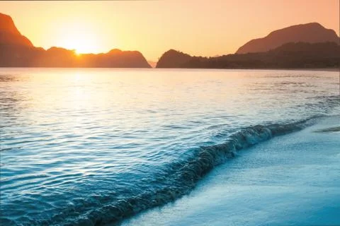 Sunset view over the beach with rock Stock Photos