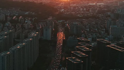 Sunset view over a bustling urban landscape highlighting traffic and cityscapes Stock Footage 311844068