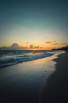 Sunset view over calm beach with gentle waves Stock Photos