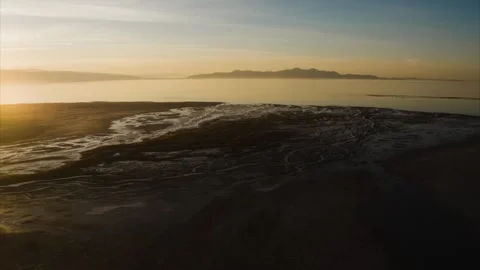 Sunset view over calm waters and distant mountains at twilight Video stock 320304168