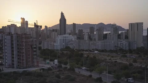 Sunset view over city skyline with buildings and mountains in the backgroun.. Stock Footage 340193653