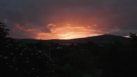 Sunset view over hills highlights vibrant colors in the evening sky Stock Footage 310239766