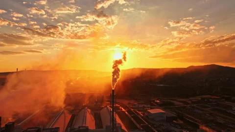 Sunset view over industrial area with smoke rising from tall chimney among Stock Footage 340961245