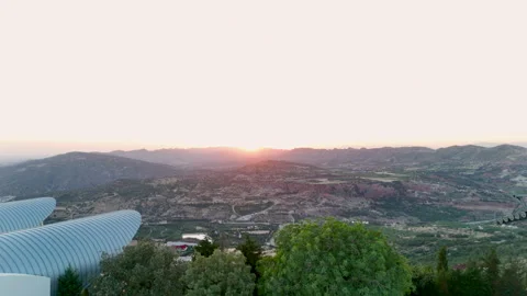 Sunset view over mountain valley with modern dome building Stock Footage 316233418