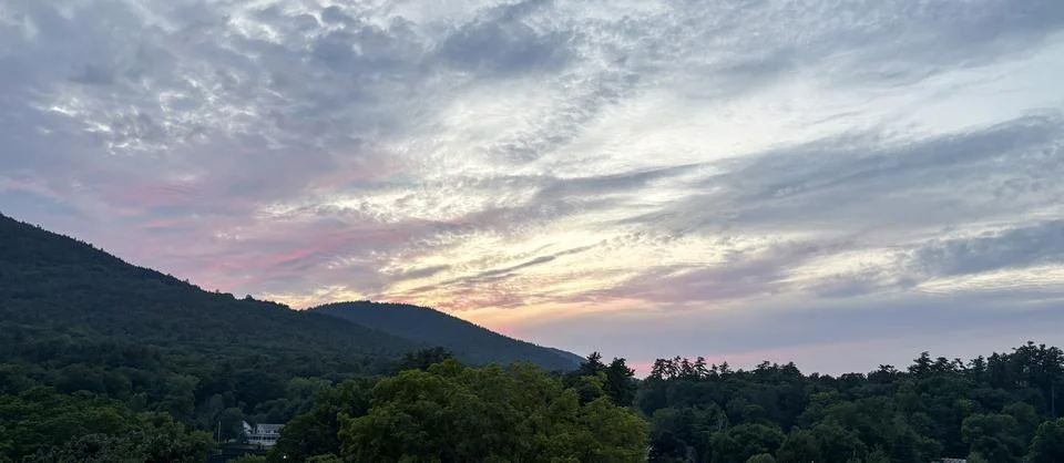 Sunset View Over Mountains With Trees and Clouds in the Sky Stock Photos