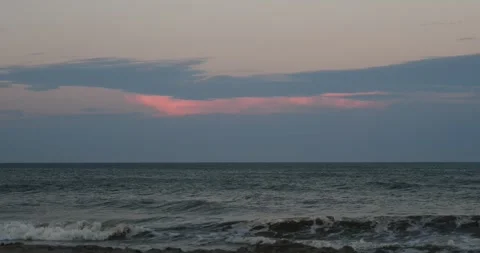 Sunset view over the ocean with gentle waves at coastline Video stock 281818950