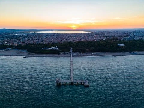 Sunset view over the pier and city with water and clouds in the background 스톡 사진