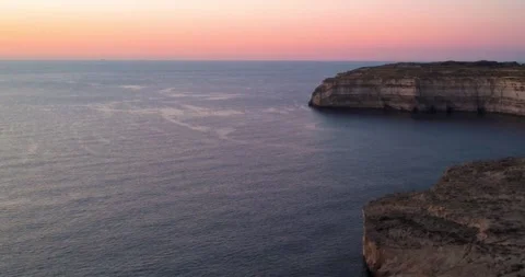 Sunset View Over the Sea and Cliffs at Dwejra Bay in Gozo, Malta During Early Stock Footage 334854688