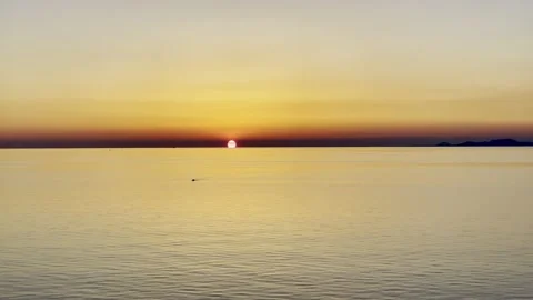 Sunset view over the sea, a kayak floats in the sea, footage Stock Footage 157639079