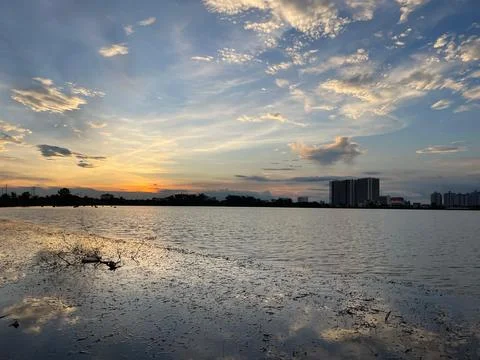 Sunset view over a wide pond with a small building  Stock Photos