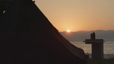 Sunset View Overlooking Sea, Silhouette of Camping Tent, Serene Evening Ambiance Stock Footage 269699115
