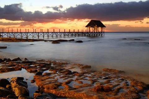 Sunset view from pier in Pointe Aux Piments, Mauritius as daylight fades into Stock Photos